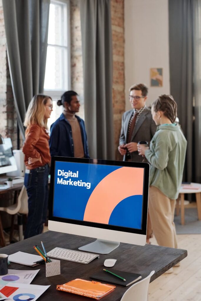 pexels photo 6476191 Business team engaged in a digital marketing discussion in a modern office setting.
